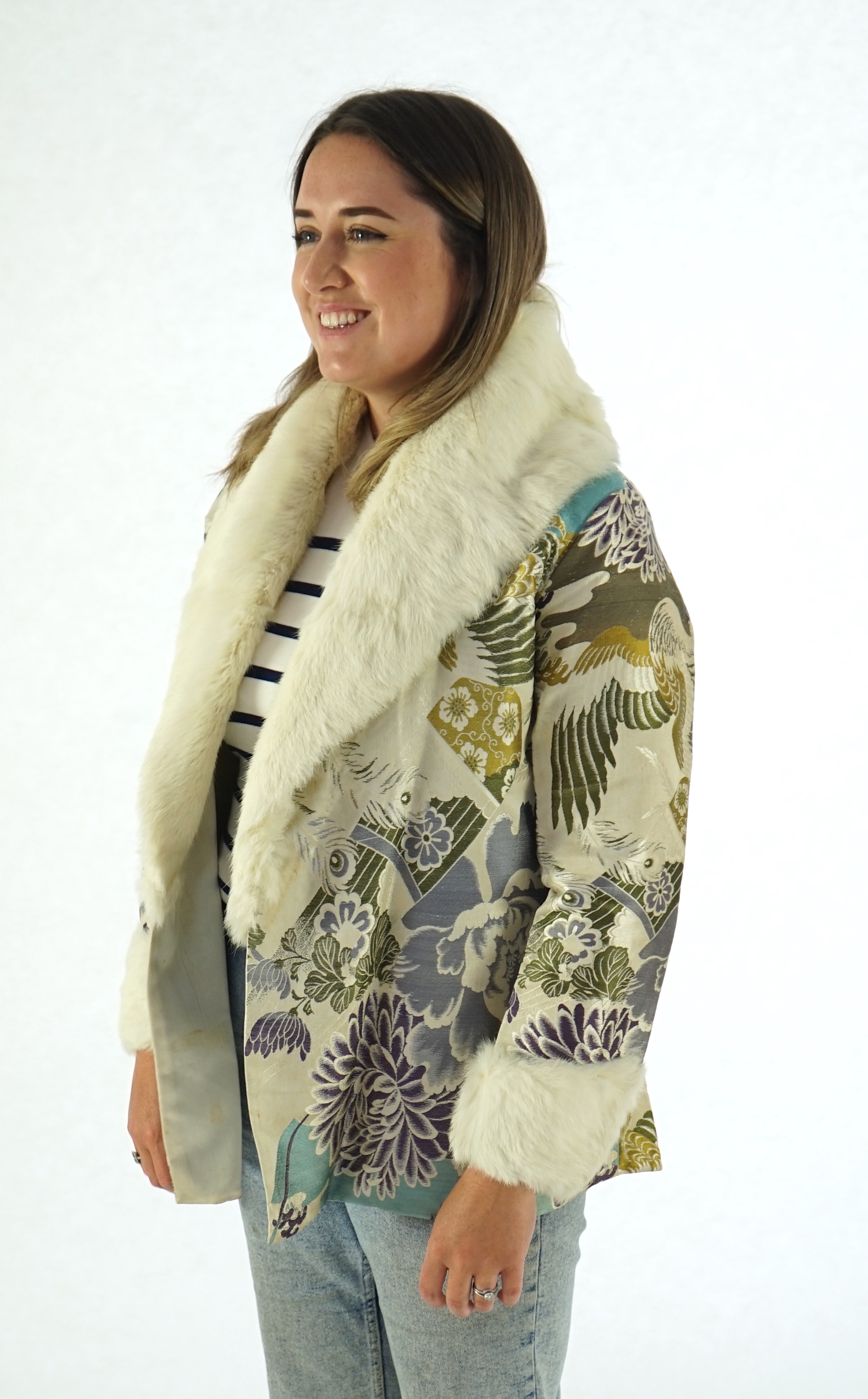 A 1940's lady's patterned brocade evening coat with white fur trim.